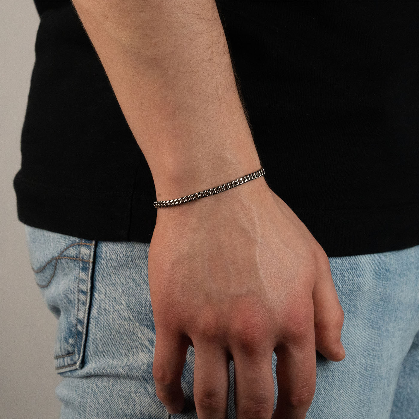 Model trägt eine silberfarbenes Cuban-Armband aus 316L Edelstahl mit einem Gewicht von 6,3 g.